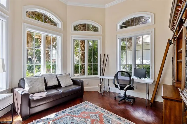 a view of a livingroom with workspace and a window