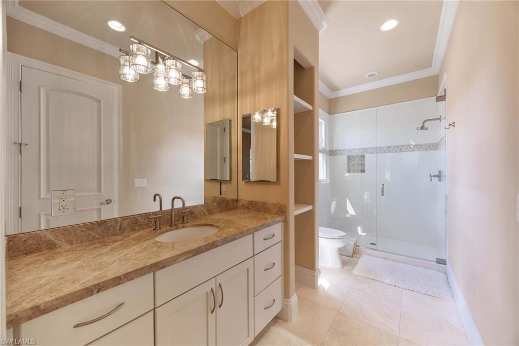 23801 Napoli Way Estero, FL 34134 - Photo 36 of 50 a spacious bathroom with a granite countertop sink a toilet a mirror and shower
