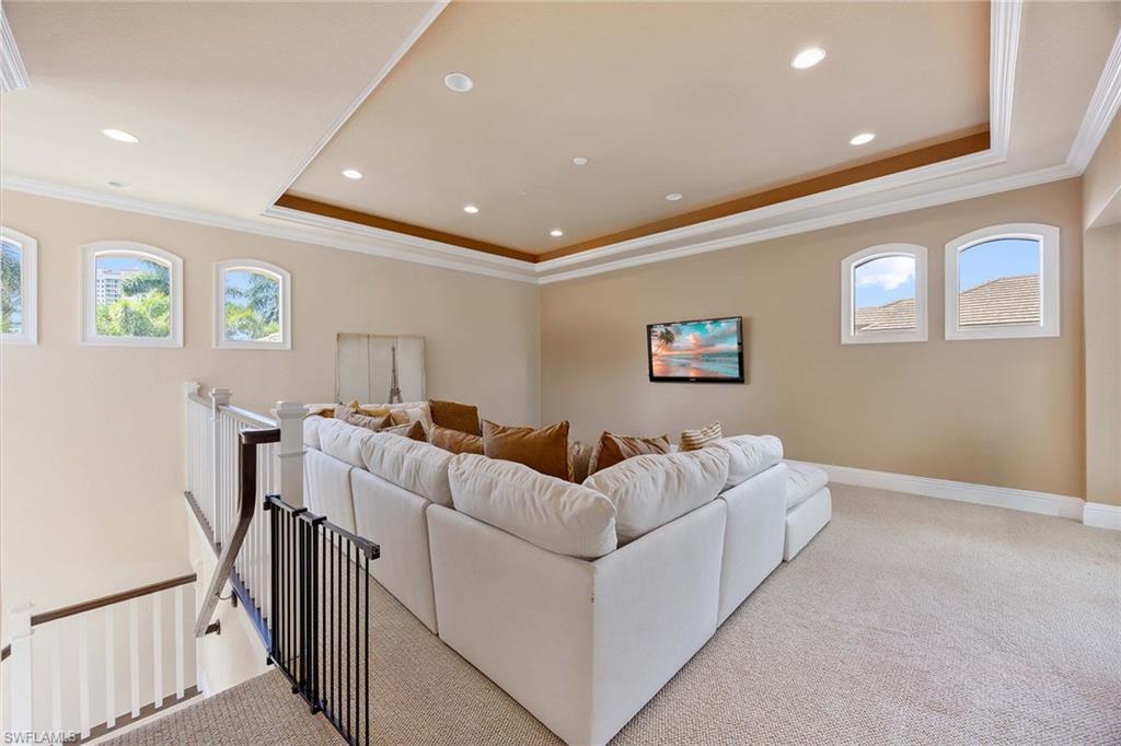23801 Napoli Way Estero, FL 34134 - Photo 37 of 50 a living room with couches and a flat screen tv
