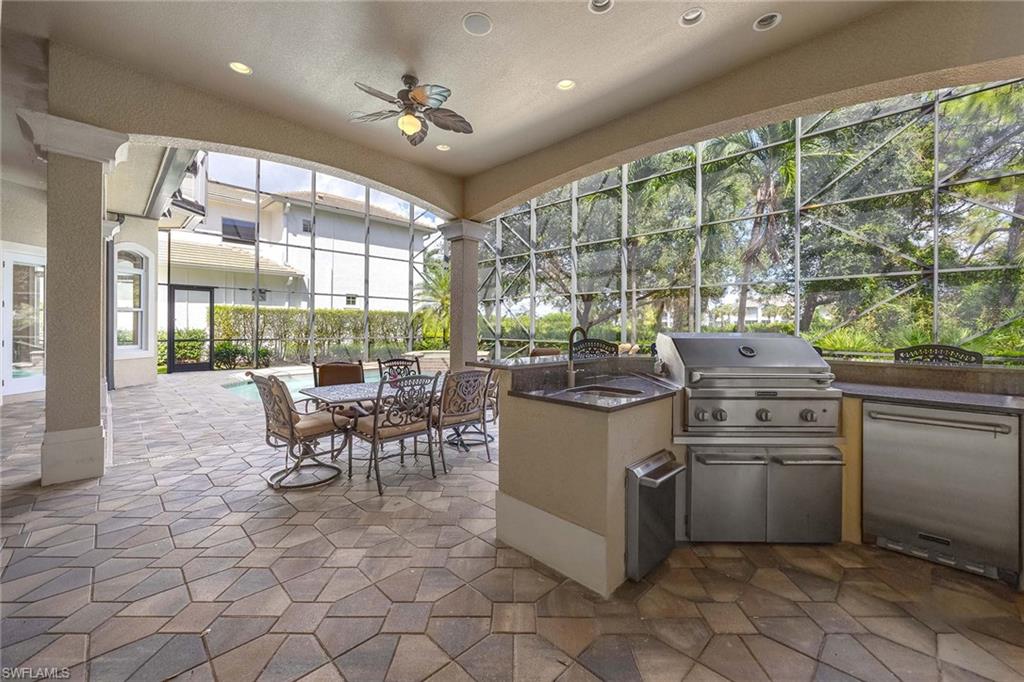 23801 Napoli Way Estero, FL 34134 - Photo 45 of 50 a kitchen with a stove dining table and chairs