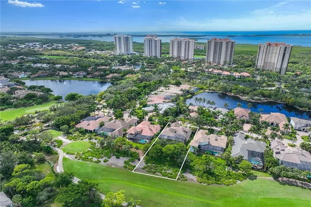 a view of a house with a yard and lake view