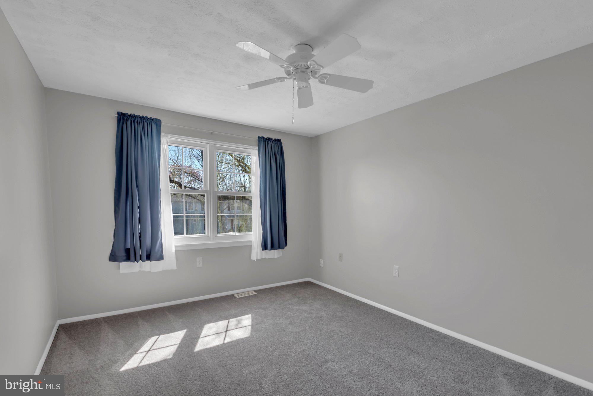 2513 Maytime Drive Gambrills, MD 21054 - Photo 22 of 40 an empty room with windows and ceiling fan