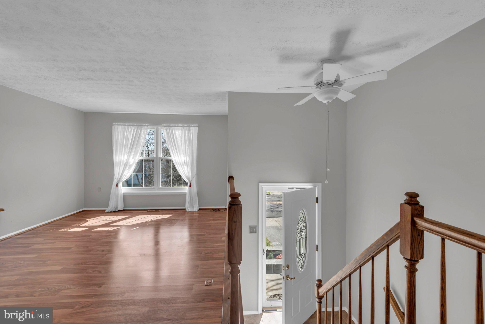 2513 Maytime Drive Gambrills, MD 21054 - Photo 4 of 40 a view of an empty room with wooden floor and a window