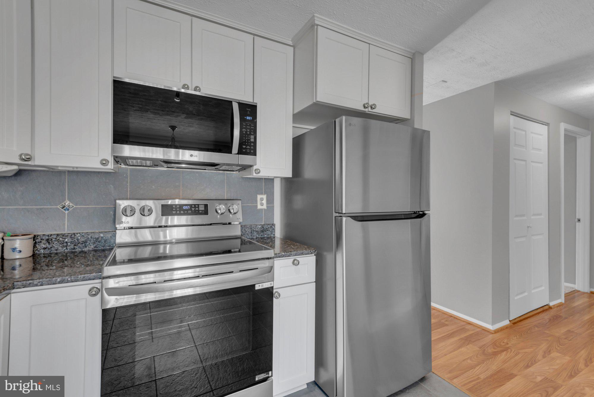 2513 Maytime Drive Gambrills, MD 21054 - Photo 8 of 40 a kitchen with stainless steel appliances white cabinets and a stove top oven