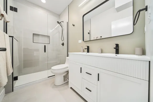 a bathroom with a toilet sink and a mirror