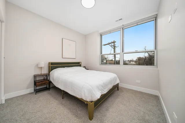 a bedroom with a bed and window