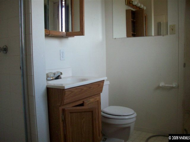 3270 Heights Reno, NV 89503 - Photo 7 of 9 a bathroom with a toilet a sink and mirror
