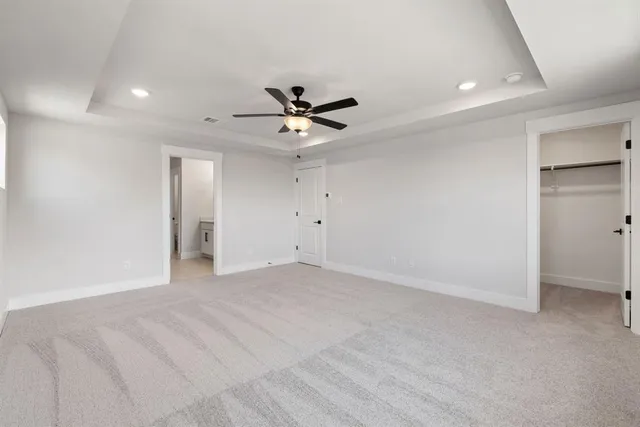wooden floor in an empty room with a ceiling fan