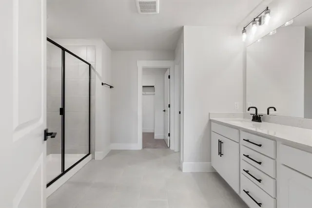 a bathroom with a double vanity sink and mirror