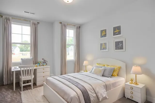 a bedroom with a bed and a table