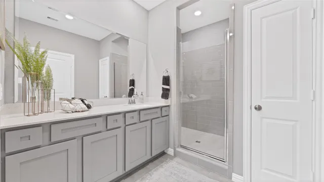 a bathroom with a double vanity sink and mirror
