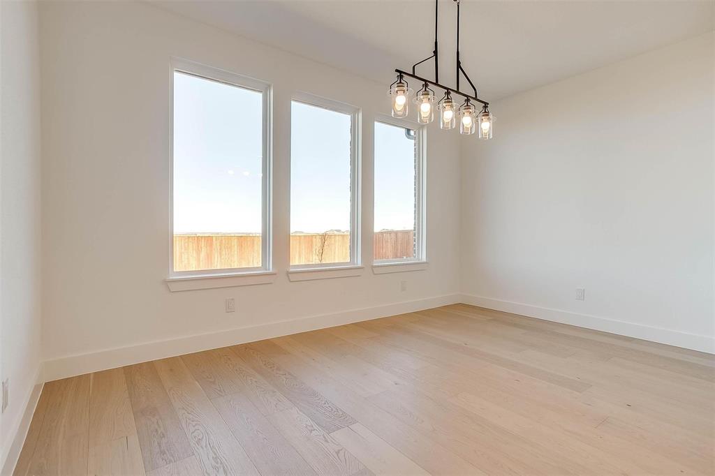 826 Feathergrass Place Haslet, TX 76052 - Photo 13 of 35 a view of an empty room with chandelier and window