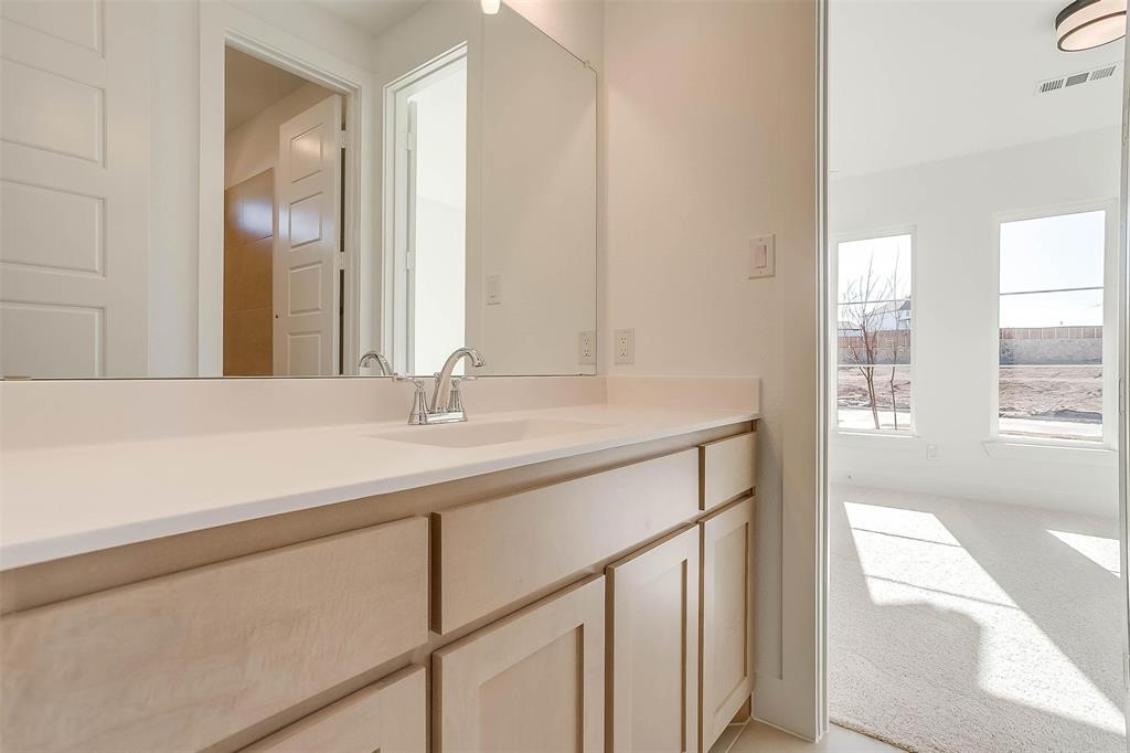 826 Feathergrass Place Haslet, TX 76052 - Photo 27 of 35 a bathroom with a sink and a mirror
