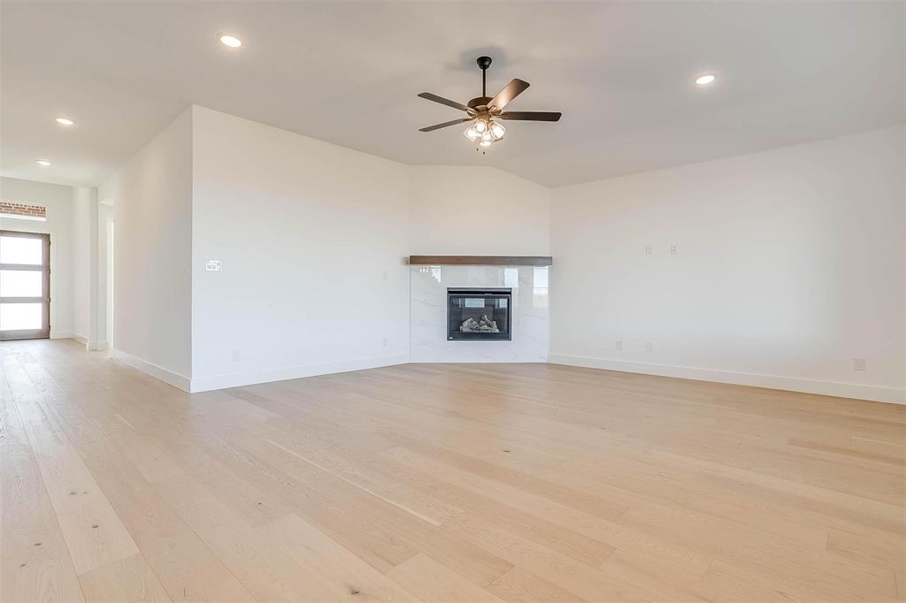 826 Feathergrass Place Haslet, TX 76052 - Photo 7 of 35 a view of a livingroom with a ceiling fan and wooden floor