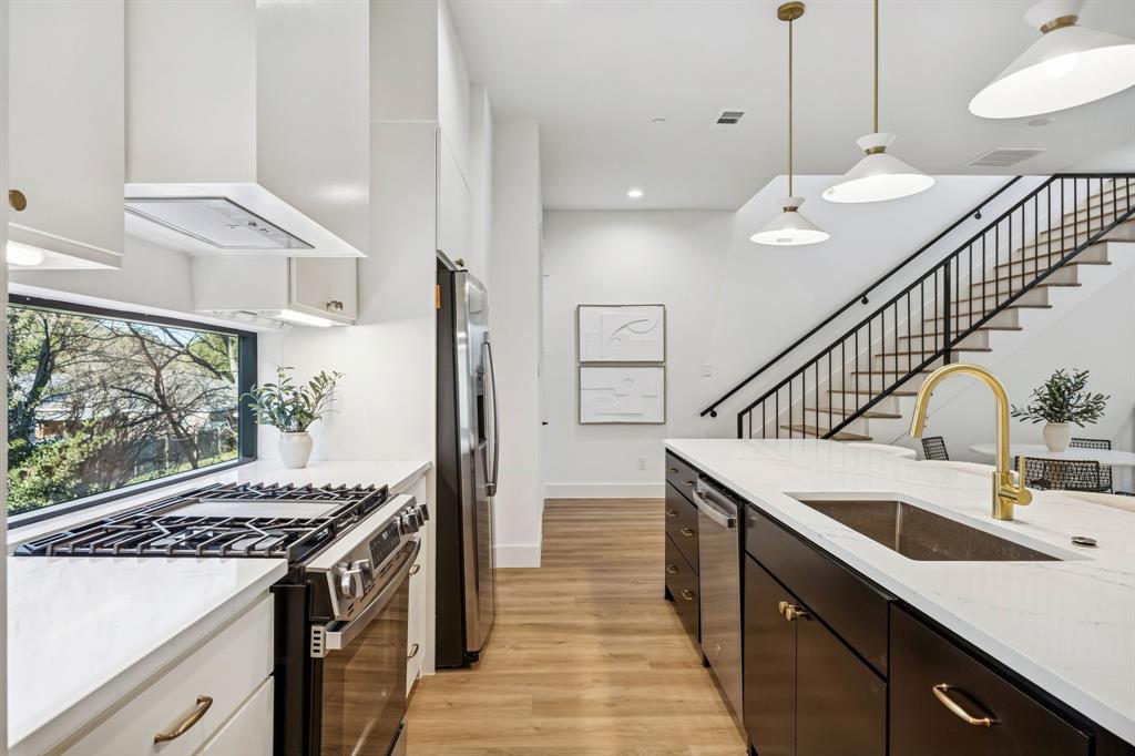 2147 Mail Avenue, Unit 103 Dallas, TX 75235 - Photo 1 of 16 a kitchen with sink stove and cabinets