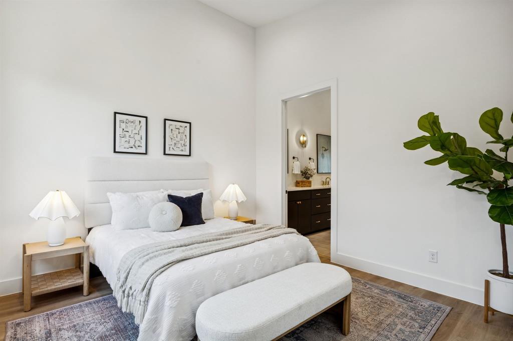 2147 Mail Avenue, Unit 103 Dallas, TX 75235 - Photo 11 of 16 a bedroom with a bed and a painting on the wall