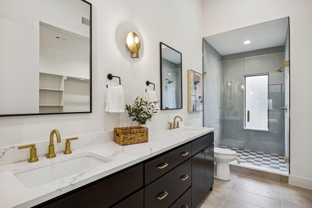 2147 Mail Avenue, Unit 103 Dallas, TX 75235 - Photo 12 of 16 a bathroom with double vanity sinks and a mirror