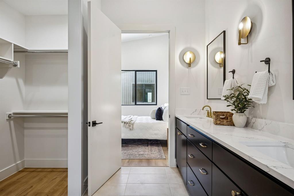 2147 Mail Avenue, Unit 103 Dallas, TX 75235 - Photo 13 of 16 a en suite bathroom with a granite countertop sink and a mirror