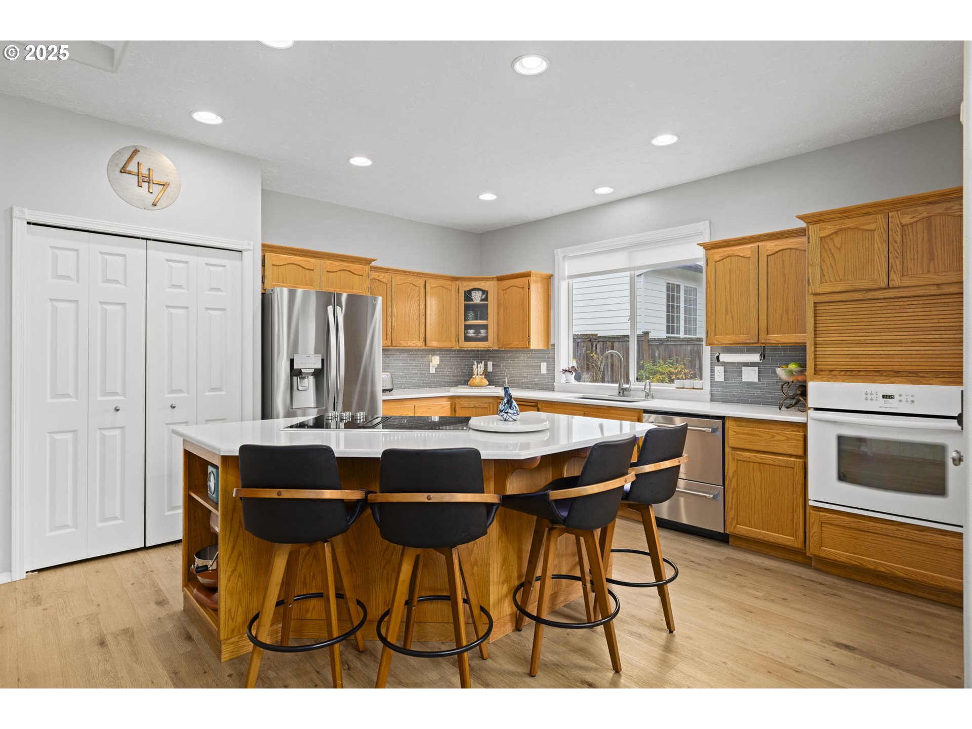 1249 Southeast Williams Avenue Gresham, OR 97080 - Photo 12 of 38 a kitchen with stainless steel appliances kitchen island granite countertop a table chairs sink and cabinets