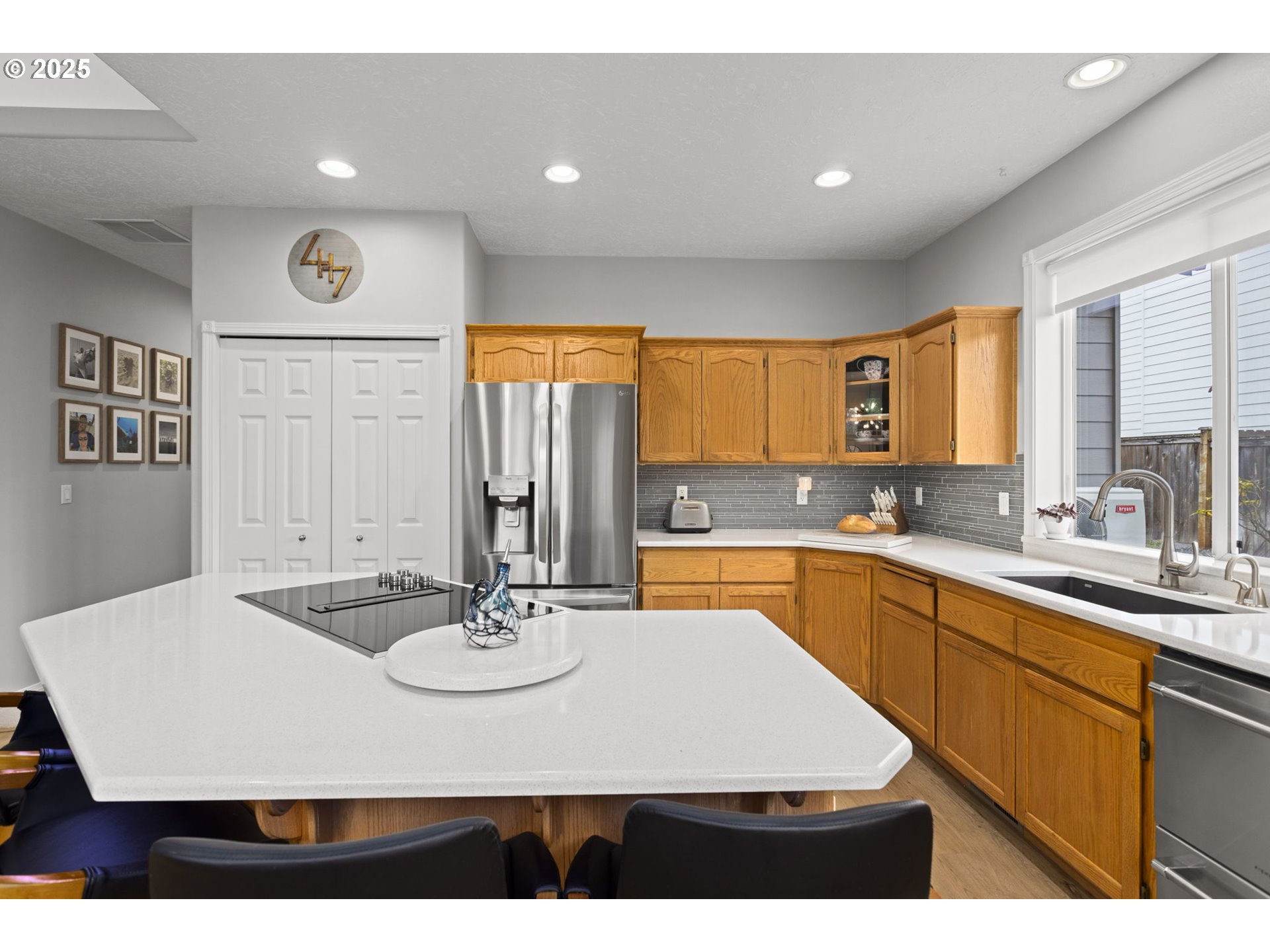 1249 Southeast Williams Avenue Gresham, OR 97080 - Photo 13 of 38 a kitchen with kitchen island a sink table and chairs