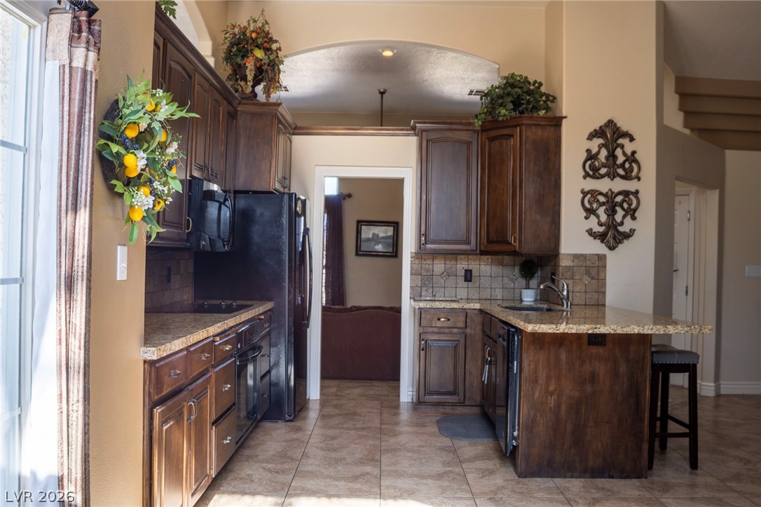 2775 Taylor Street Logandale, NV 89021 - Photo 19 of 41 This spacious kitchen offers ample cabinetry, modern appliances, and a convenient breakfast bar.