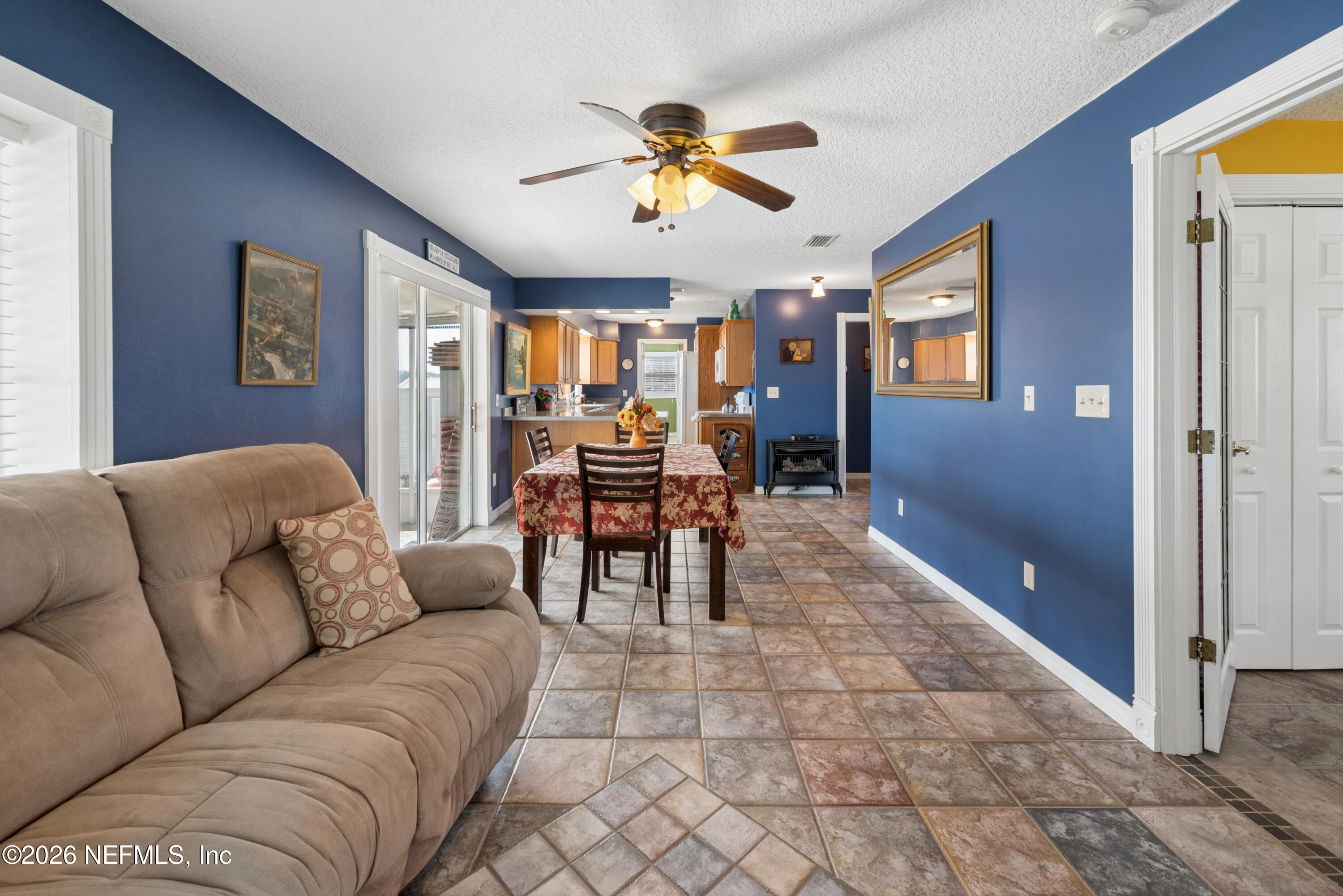 7932 Southwest County Road 18 Hampton, FL 32044 - Photo 11 of 39 a living room with furniture and a chandelier