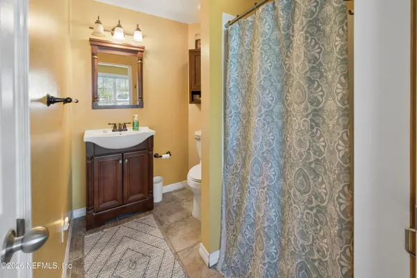 a kitchen with stainless steel appliances granite countertop a table chairs sink and cabinets