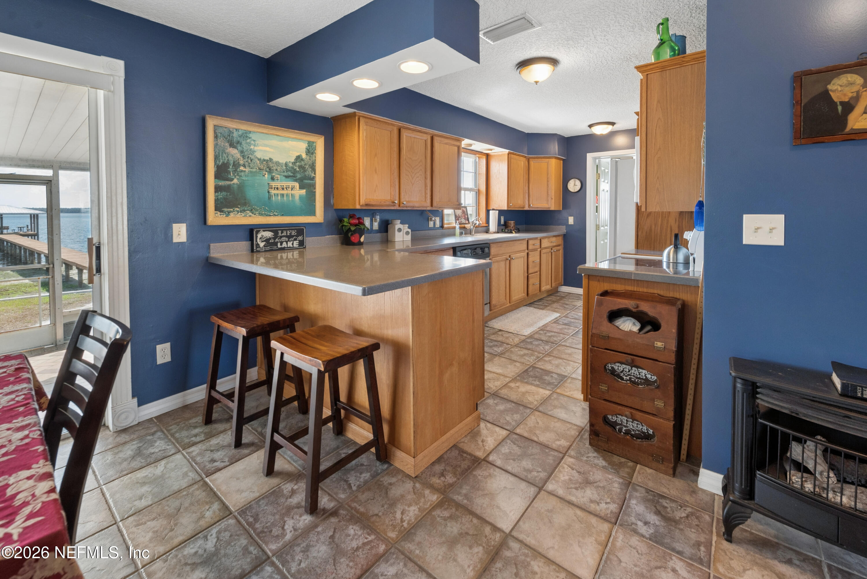 7932 Southwest County Road 18 Hampton, FL 32044 - Photo 16 of 39 a kitchen with stainless steel appliances granite countertop a table chairs sink and cabinets