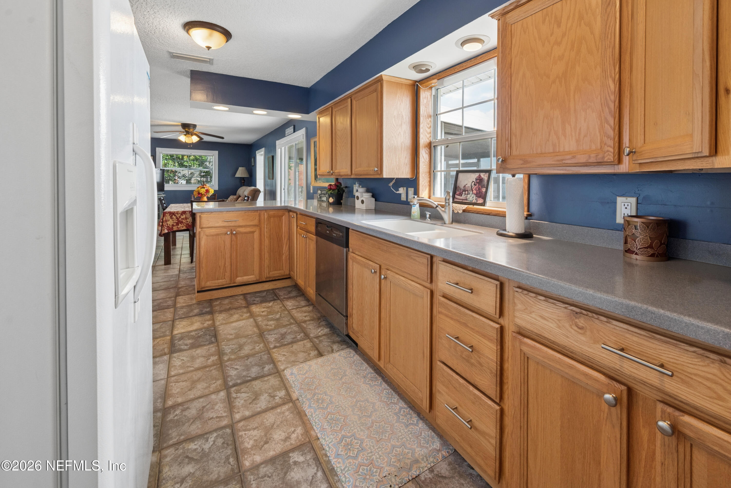 7932 Southwest County Road 18 Hampton, FL 32044 - Photo 18 of 39 a kitchen with sink cabinets and window