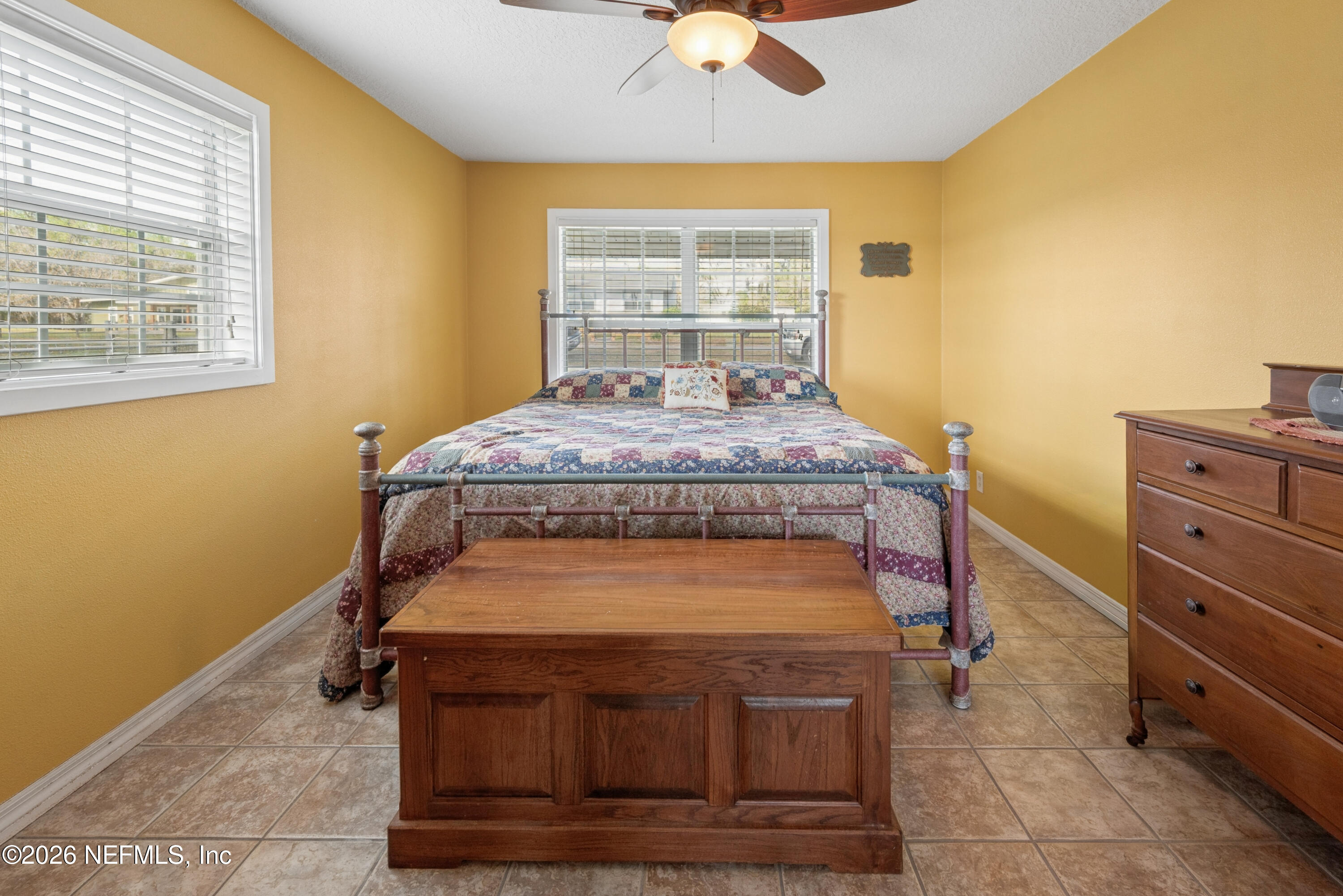 7932 Southwest County Road 18 Hampton, FL 32044 - Photo 19 of 39 a bed sitting in a bedroom next to a window