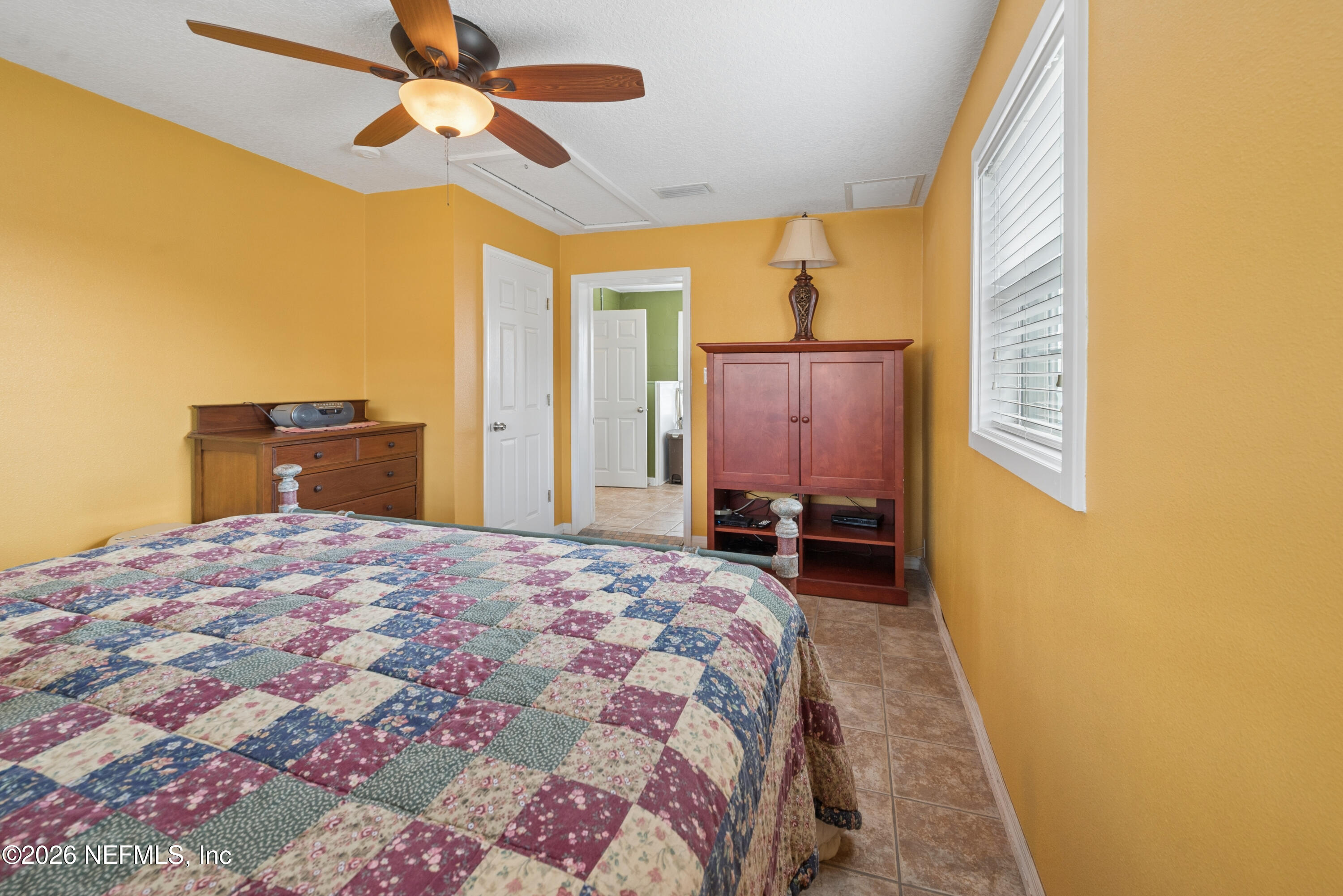 7932 Southwest County Road 18 Hampton, FL 32044 - Photo 20 of 39 a bedroom with a bed dresser and a window