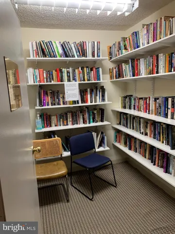 a living room with a book shelf and a book shelf