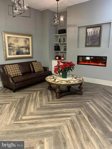 a living room with furniture and flowers