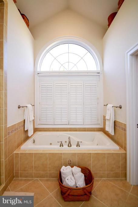 553 Houck Road Westminster, MD 21157 - Photo 20 of 30 a bathroom with a tub a rug and a window