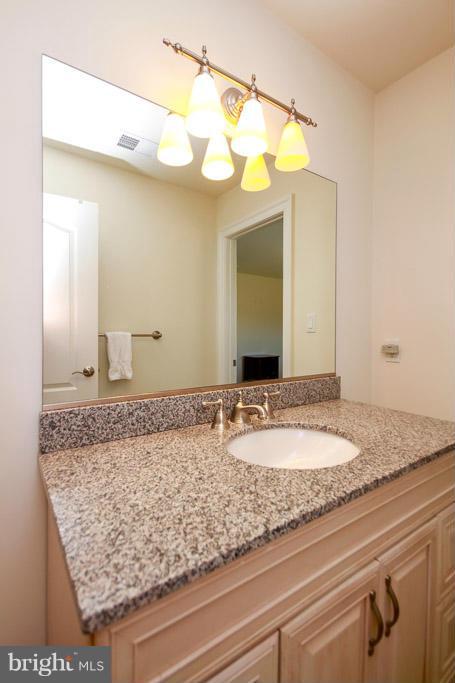 553 Houck Road Westminster, MD 21157 - Photo 26 of 30 a bathroom with a granite countertop sink and a mirror