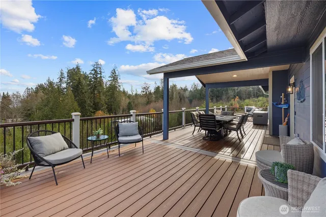 a view of a patio with table and chairs potted plants with large tree