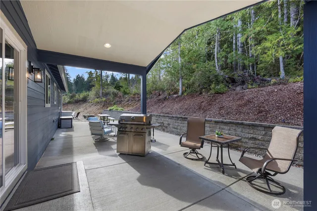 a view of a patio with table and chairs and potted plants