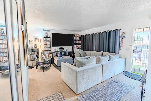 a view of a livingroom with furniture and workspace