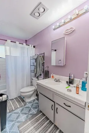 a front view of a house with a garden and plants