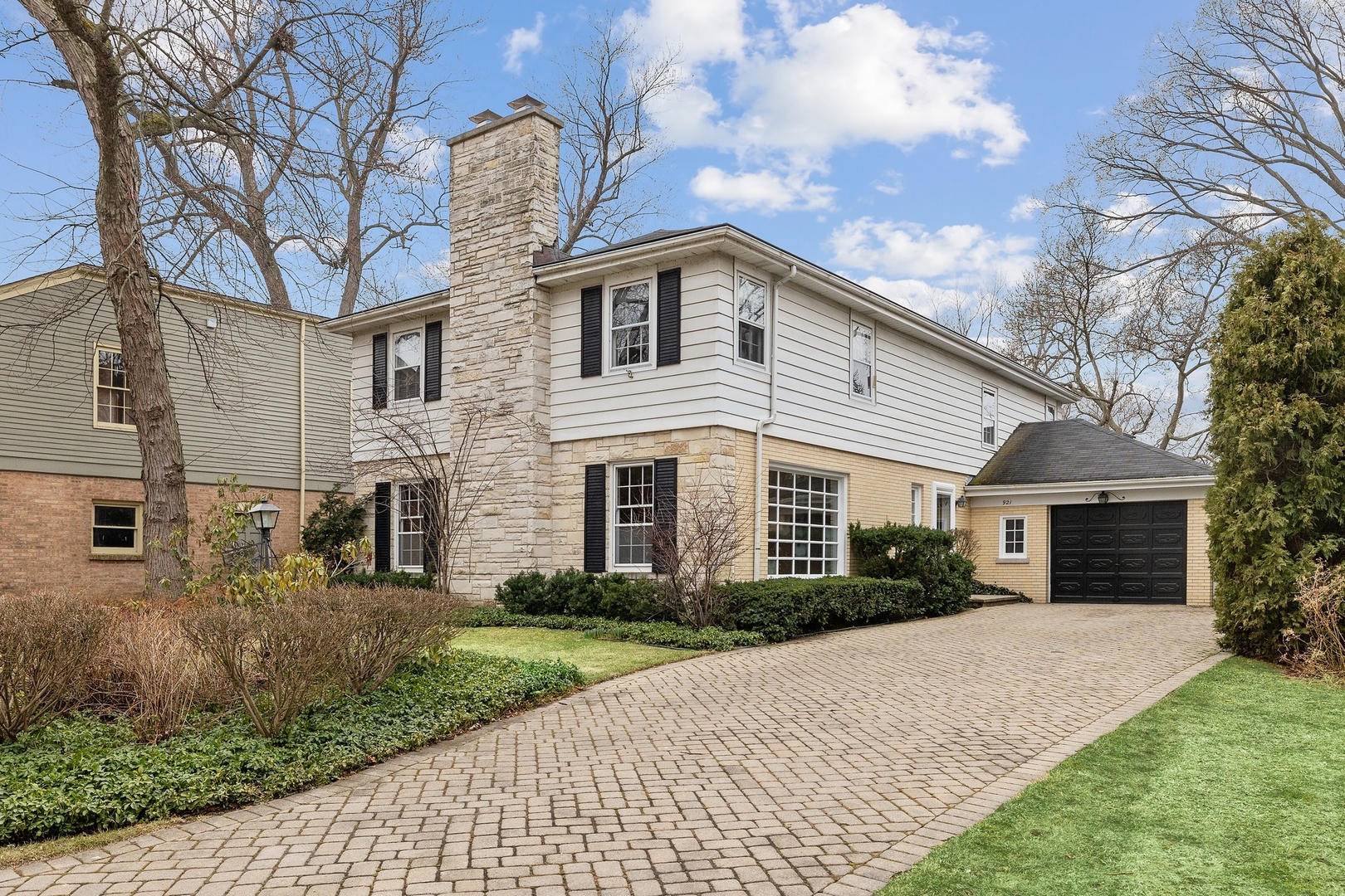 921 Pontiac Road Wilmette, IL 60091 - Photo 1 of 40 a front view of a house with garden and trees