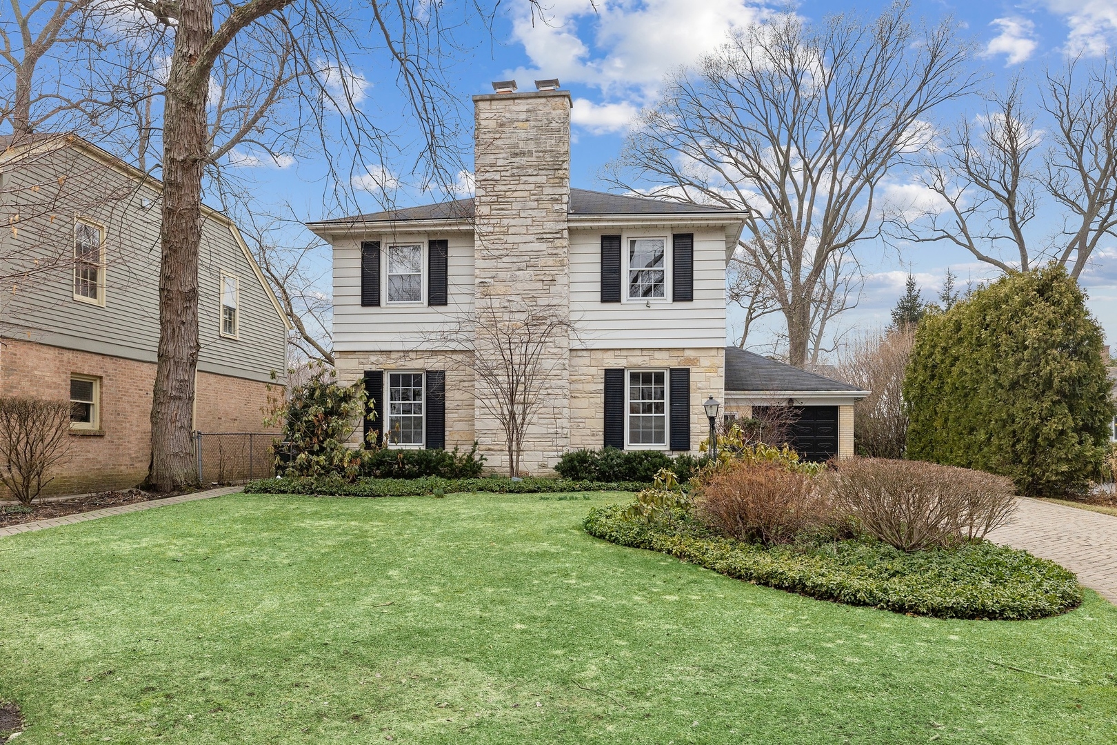 921 Pontiac Road Wilmette, IL 60091 - Photo 2 of 40 a front view of a house with a garden