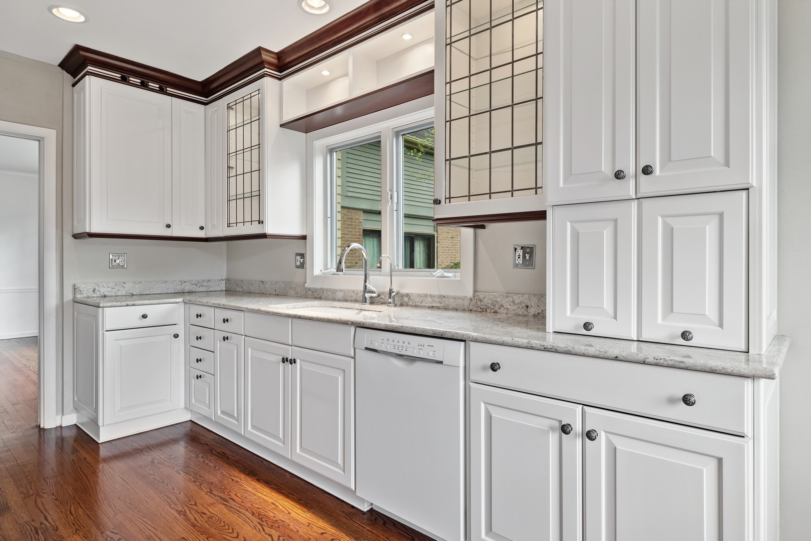 921 Pontiac Road Wilmette, IL 60091 - Photo 11 of 40 a kitchen with granite countertop white cabinets and a sink