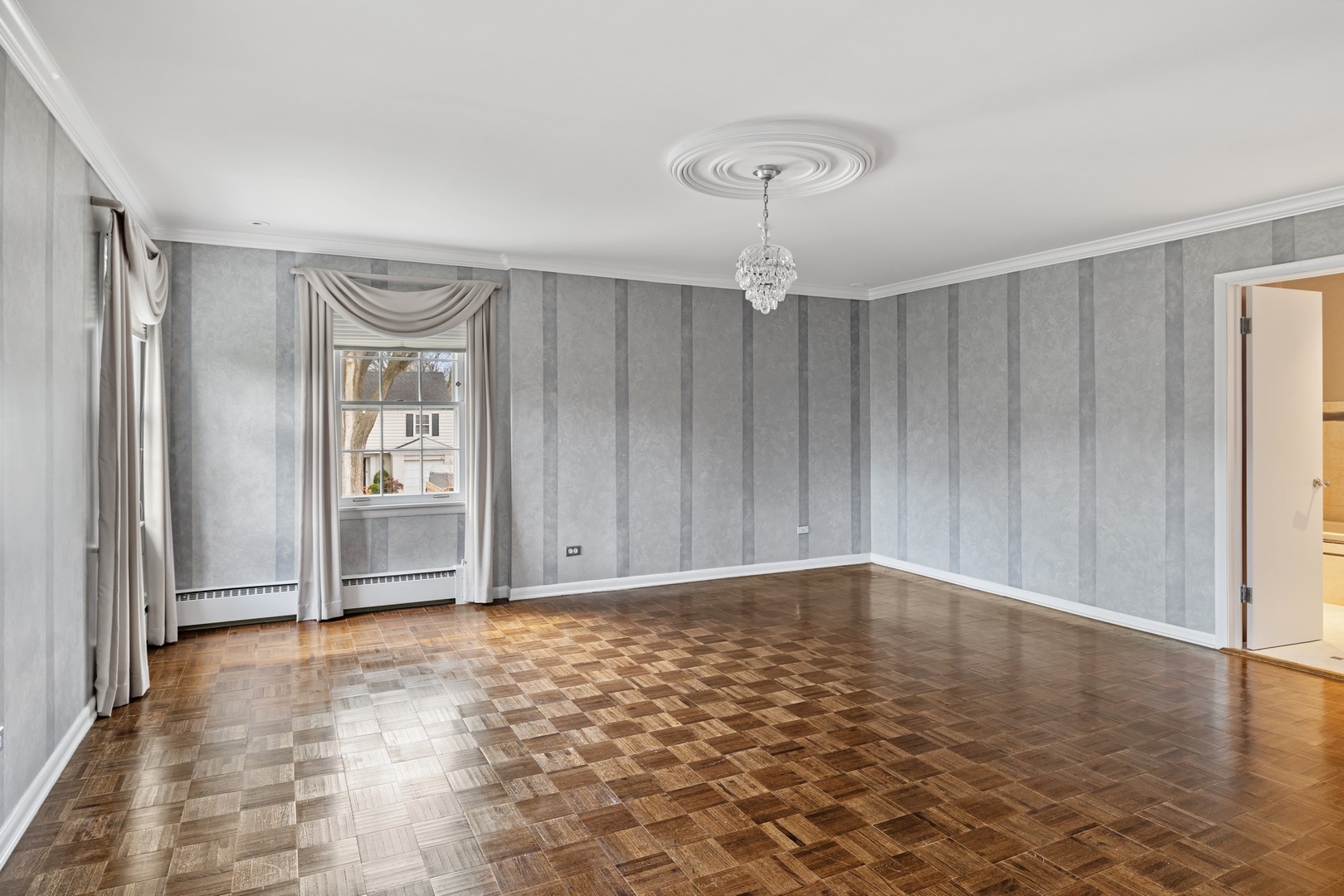921 Pontiac Road Wilmette, IL 60091 - Photo 18 of 40 a view of an empty room with wooden floor and a window