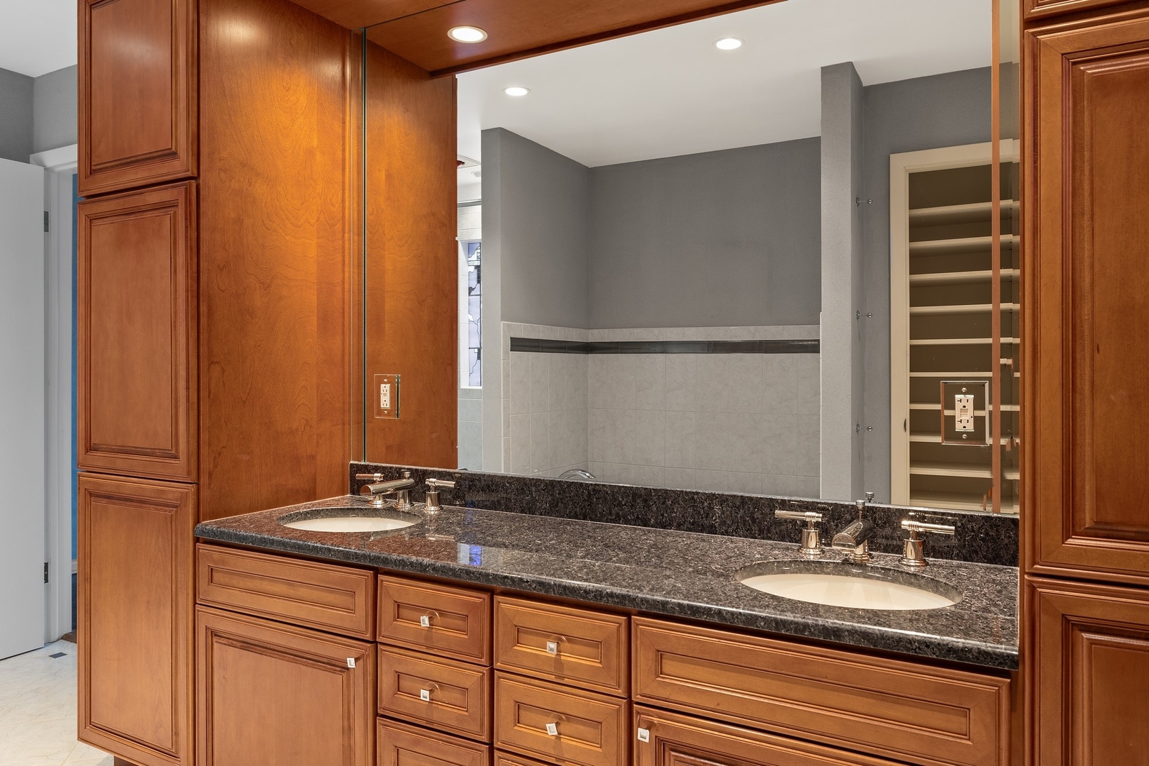 921 Pontiac Road Wilmette, IL 60091 - Photo 20 of 40 a bathroom with a granite countertop sink and a mirror