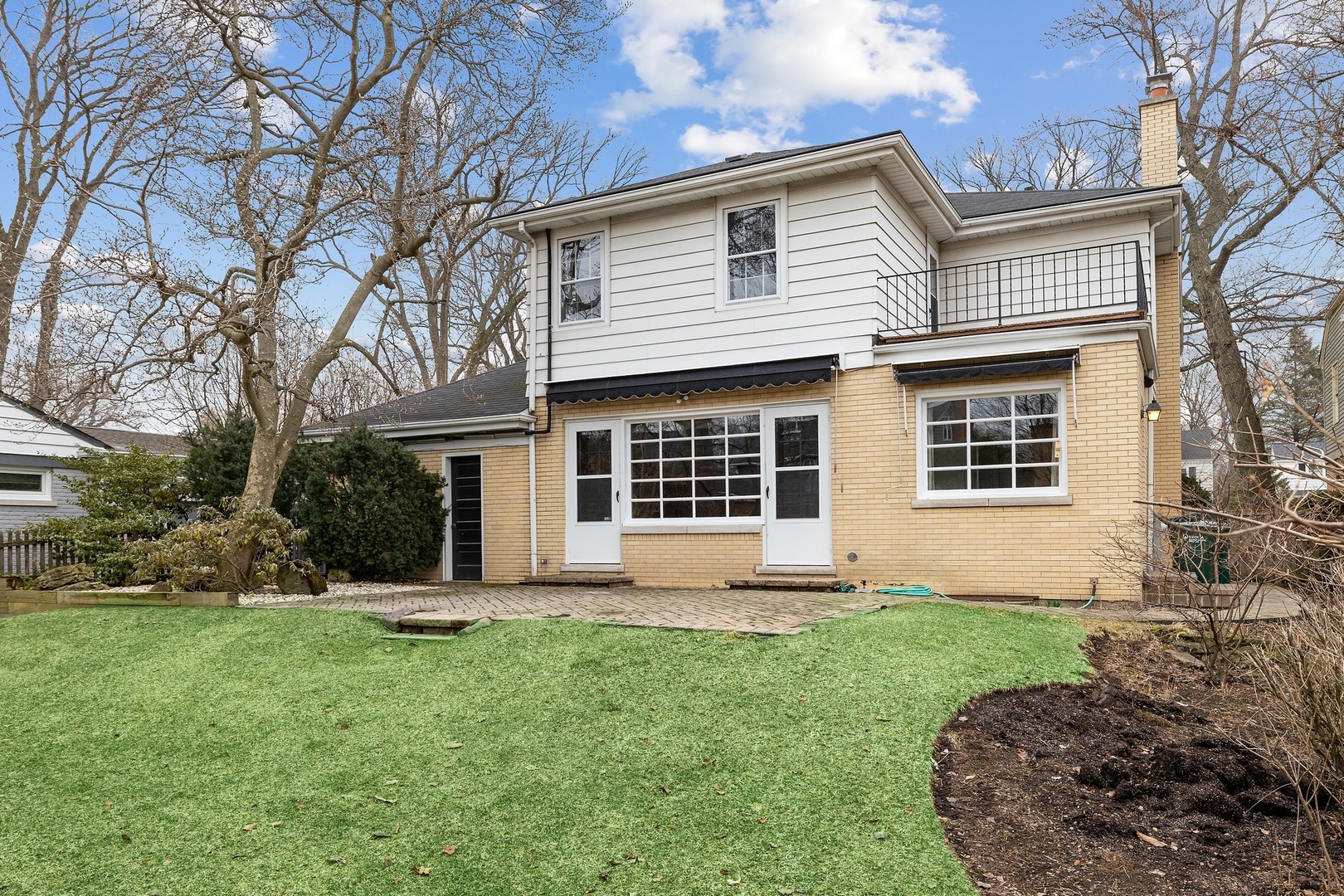 921 Pontiac Road Wilmette, IL 60091 - Photo 35 of 40 a front view of a house with a yard and garage