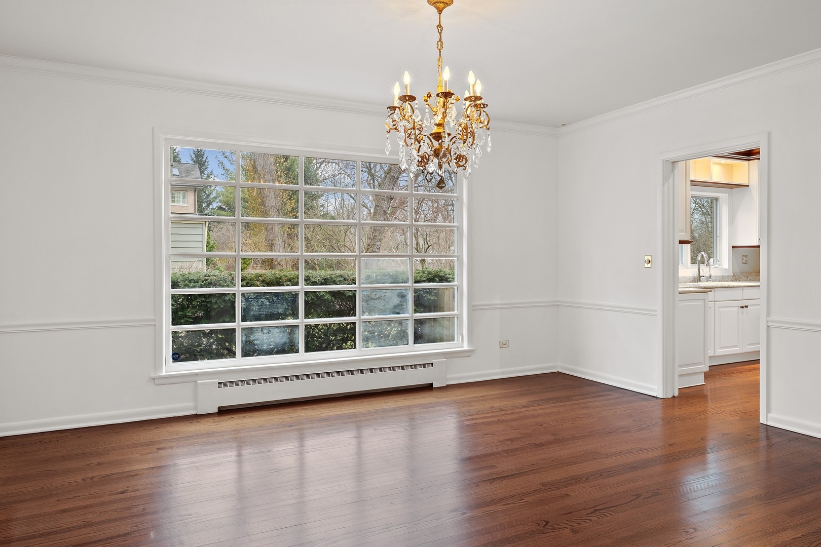 921 Pontiac Road Wilmette, IL 60091 - Photo 8 of 40 a view of an empty room with wooden floor and a window