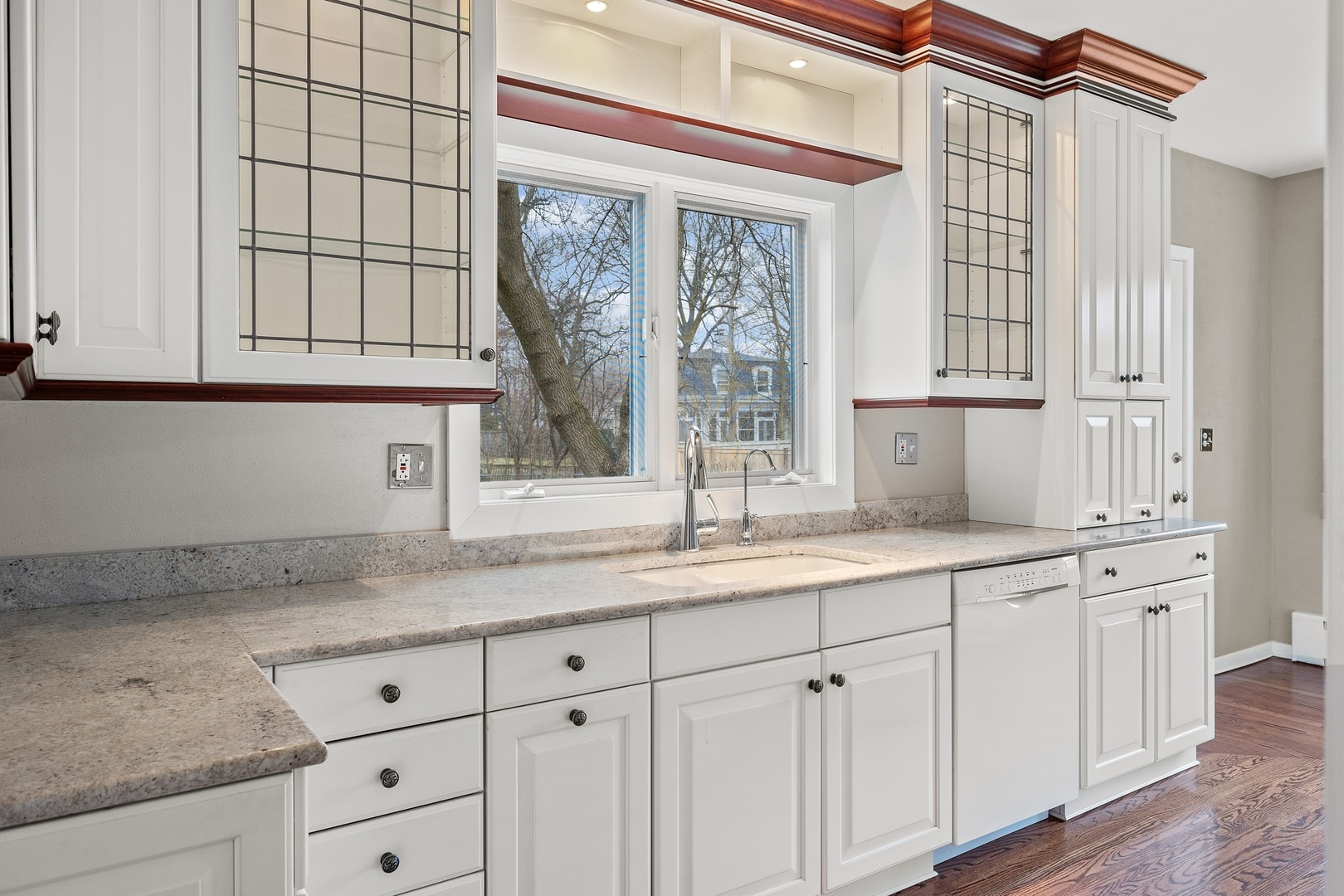 921 Pontiac Road Wilmette, IL 60091 - Photo 10 of 40 a kitchen with granite countertop white cabinets and a window