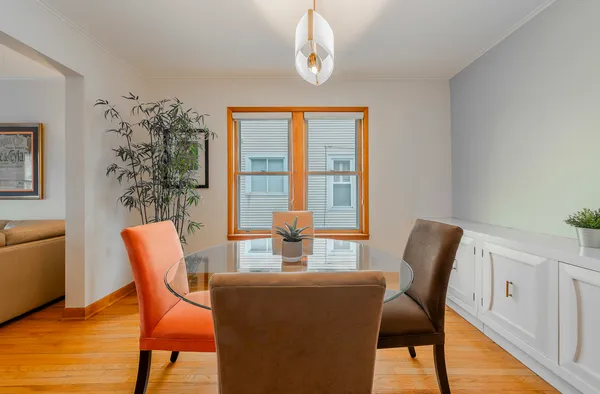 a dining room with furniture a window and wooden floor