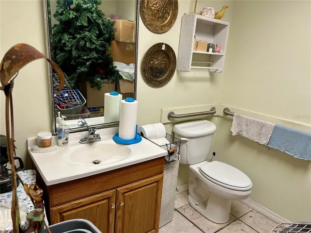 a bathroom with a toilet a sink and a mirror
