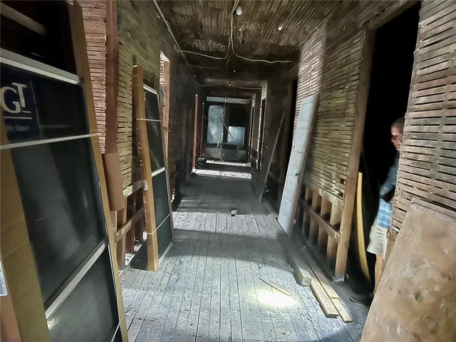 a view of a hallway with wooden floor and glass door